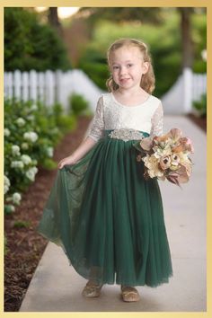 Holiday Dress in Green Looking for that special holiday dress for your little princess? Our Girls Green Christmas Dress is the perfect combination of festive and chic! The rich hunter green hue will make her feel like a fairy at a Christmas party, while the charming design will have her feeling confident and beautiful. This long sleeve, full-length piece perfectly captures the magic of Christmas. With its rich hues echoing the evergreens, your little one will shine at any special occasion. The d Green Christmas Dress, Green Holiday Dress, Ethereal Forest, Wedding Kids Outfit, Green Flower Girl Dresses, 21st Ideas, Hunter Green Dresses, Long Flower Girl Dresses, Lace Back Dresses