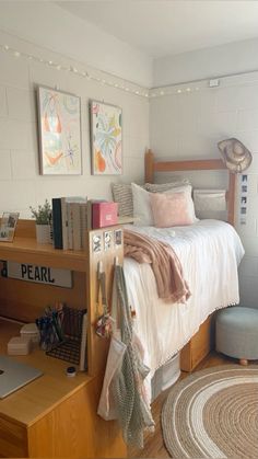 a bedroom with a bed, desk, and bookshelf on the wall above it