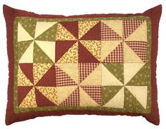 a red and green patchwork pillow on a white background