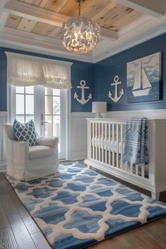 a baby's room with blue walls, white furniture and a chandelier