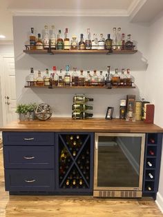 a wine rack with bottles on top of it next to a counter in a room