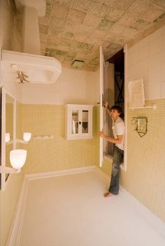 a man standing in the doorway of a bathroom