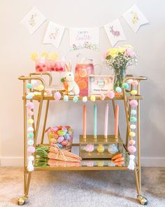 a gold bar cart with candles and decorations on it