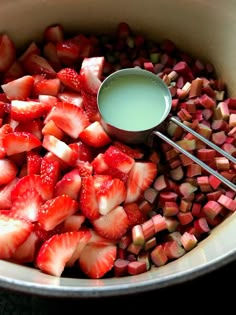 strawberries and celery being mixed together in a pot