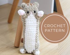 a crocheted stuffed animal sitting on top of a wooden floor