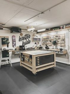 a workbench with many tools on it in a room that looks like an art studio