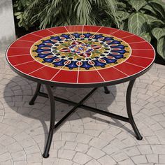 Add a pop of color to your space with a Mosaic Coffee Table. An elevated take on a traditional design, a vibrant red tile design compliments a black frame. Curving to the classic 4-leg design base provides visual interest with needed support. Compatible with indoor and outdoor use, this coffee table works anywhere in your home. Powder-coated steel and ceramic tile are weather and water-resistant for durability. Easy assembly allows you to set up this tiled coffee table in a snap. Lark Manor™ | L Mosaic Table Top Designs, Mosaic Outdoor, Mosaic Coffee Table, Tiled Coffee Table, Mosaic Table Top, Bistro Table Outdoor, Red Tiles, Outdoor Coffee Table, Mosaic Table