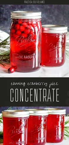 three jars filled with cranberry juice on top of a white tablecloth next to pine branches