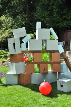 a bunch of angry birds made out of cardboard boxes and crates sitting in the grass