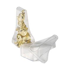 a clear plastic container with some gold pieces in it