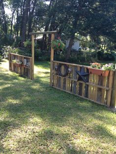 two wooden planters with plants in them on the grass