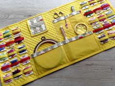 a yellow quilted placemat with sewing supplies on it