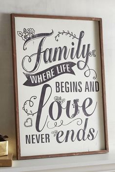 a sign that says family where life begins and love ends on the wall above a fireplace