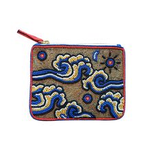 an embroidered pouch with blue and yellow designs on the front, sitting on a white surface