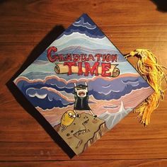 a graduation cap with the words graduation time painted on it and a tassel attached to it