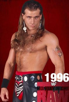 a man with long hair and no shirt is wearing a wrestling outfit while standing in front of a red background