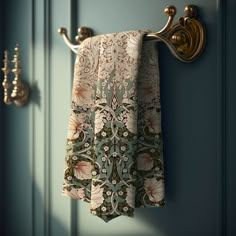 a curtain hanging on the side of a blue door next to a gold towel rack