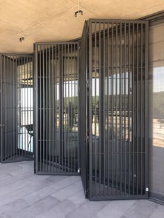 the doors are open to let in some light and water inside an enclosed area with stone flooring