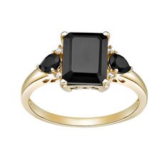 a black diamond ring with three stones on the side and two diamonds at the top