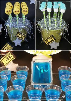 blue and yellow desserts are displayed in plastic cups