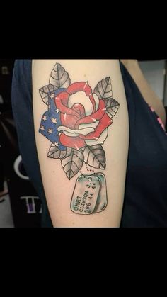 a woman's arm with a rose and weight scale tattoo on it