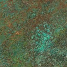 an image of a green and brown surface that looks like it has been scratched or stained