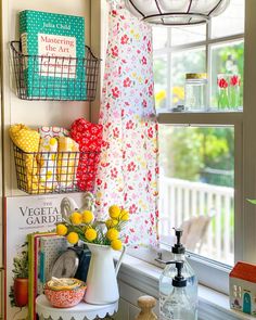 a kitchen window sill filled with lots of colorful items next to a potted plant