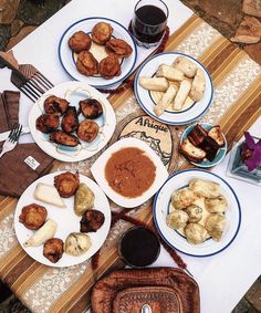 a table topped with plates of food and drinks