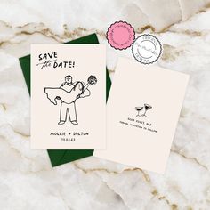 save the date cards with envelopes on marble background