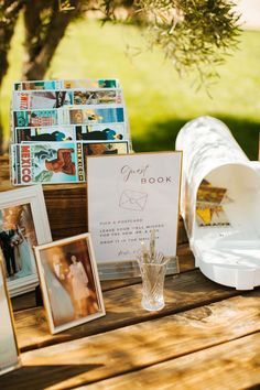 a wooden table topped with pictures and photos next to a mailbox on top of it