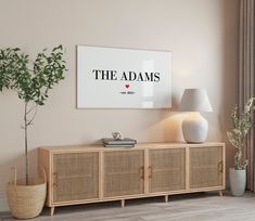 a living room with a large poster on the wall and a potted plant next to it