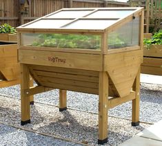 a wooden structure with plants growing in it