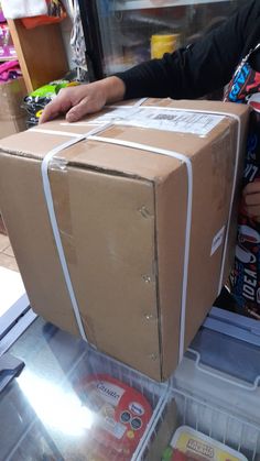 a cardboard box sitting on top of a refrigerator