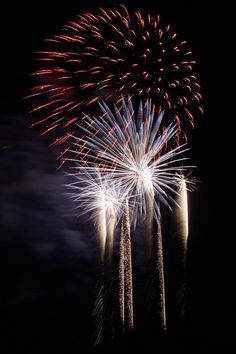 fireworks are lit up in the night sky