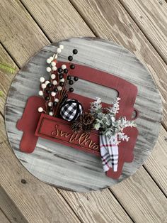 a wooden sign that says sallie with some flowers in it on top of a table