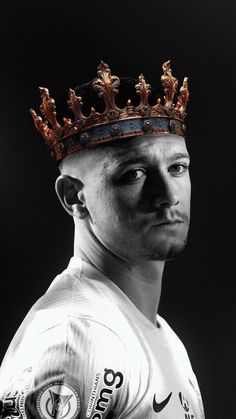 a black and white photo of a man wearing a crown