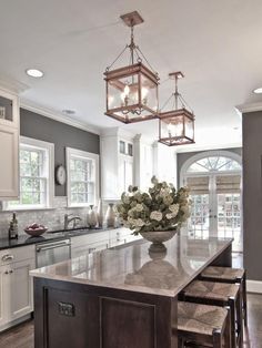 a large kitchen with an island in the middle