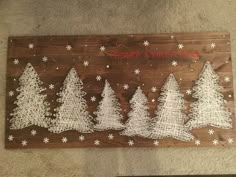 a wooden sign with christmas trees on it