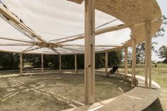 a large wooden structure with white fabric covering it