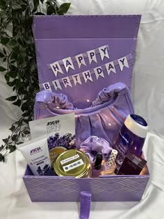 a purple birthday gift box filled with personal care products and gifts for someone's special occasion