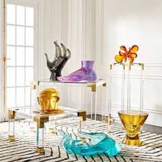 there are many glass vases on display in this room, and one is colorful