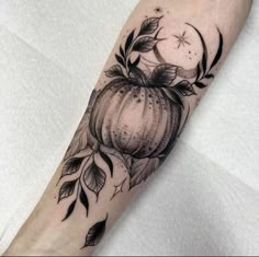 a black and white photo of a pumpkin with leaves on it's arm,