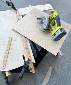 a table with some tools on top of it next to a pair of plywood planks