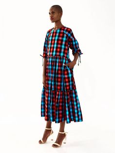 This fabric is called ‘Maasai Shuka’ and is the traditional fabric worn by the Maasai Tribe in Kenya and Tanzania. The Tiered Dress has pockets and drawstring sleeves. The beads on the dress are made from recycled glass by members of the Krobo tribe in Ghana, by using a centuries old technique. The crushed glass is shaped is heated over a fire in moulds which are made from mud. That gives the beads their frosty and uneven texture. The colour of the beads on your dress is determined by the type o Recycled Glass Bead, Mid Length Sleeves, Crushed Glass, Traditional Fabric, Maasai, A Fire, Tiered Dress, Recycled Glass, Tanzania