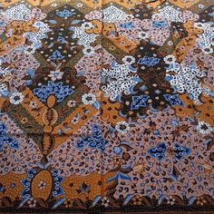 an intricately designed area rug with blue, yellow and brown colors