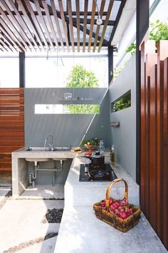 an outdoor kitchen with a sink, stove and counter top in the middle of it