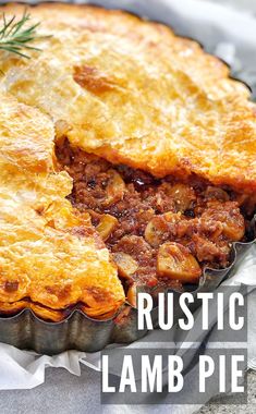 a close up of a pie in a pan with the words rustic lamb pie on it