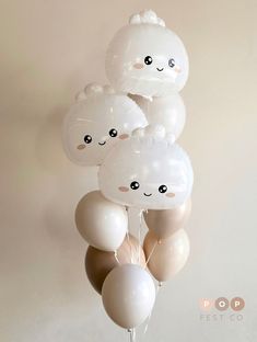 a bunch of balloons with faces on them