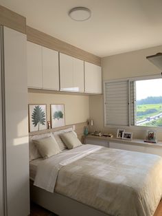 a bedroom with a bed, dressers and window in the corner is shown here