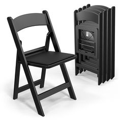 a black folding chair next to a small stove with it's door open and the seat up